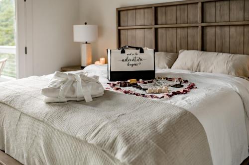 a bed with a tray of food and a sign on it at The Glass Chalet in Williamsburg