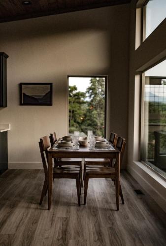 a dining room with a table and chairs and a window at The Glass Chalet in Williamsburg