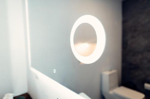 a bathroom with a mirror on the wall and a toilet at Luxury Villa Ceibo - Exquisite, Private, Serene in San Mateo