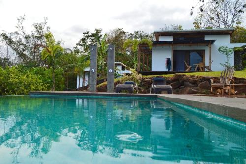 a swimming pool in front of a house at Luxury Villa Ceibo - Exquisite, Private, Serene in San Mateo