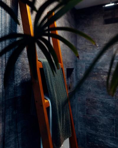 a chair with a towel on it next to a plant at Luxury Villa Ceibo - Exquisite, Private, Serene in San Mateo