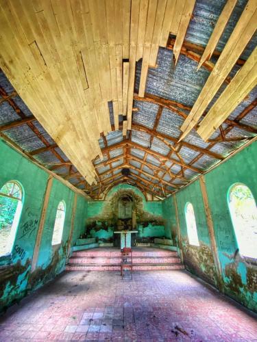 an empty room with a wooden ceiling in an abandoned building at Luxury Villa Ceibo - Exquisite, Private, Serene in San Mateo