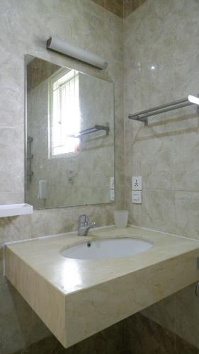 a bathroom with a sink and a mirror at Diyar Villas Puncak M6/12 in Puncak