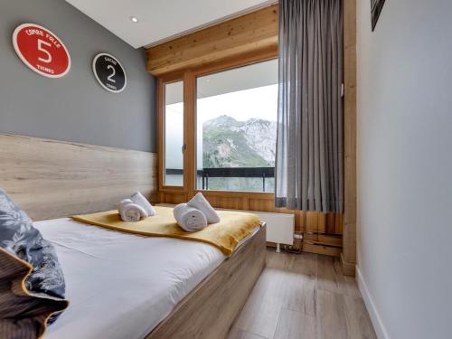 a bedroom with a bed and a large window at Appartement pour 4 pers à Tignes le Lac - Balcon, proche pistes et commerces - FR-1-641-120 in Tignes
