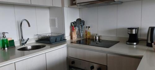 a kitchen with a sink and a counter top at Departamento con vista al mar en Puerto Montt in Puerto Montt