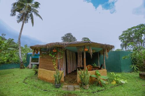 a small house with a thatched roof at Sparrow's House in Weligama