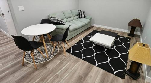 a living room with a couch and a table and chairs at Guest Home Near Regina Airport YQR in Regina