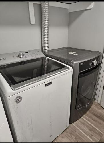 a small kitchen with a stove and a dishwasher at Guest Home Near Regina Airport YQR in Regina