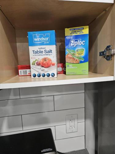 a shelf with two boxes of food on it at Guest Home Near Regina Airport YQR in Regina
