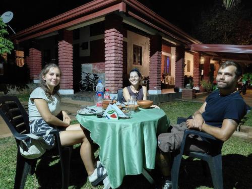 a group of people sitting at a table at Mahi's Place in Minneriya