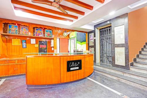 a lobby of a restaurant with a counter and stairs at Collection O Besant Road in Vijayawāda