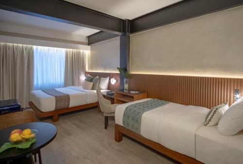 Ένα ή περισσότερα κρεβάτια σε δωμάτιο στο Amari-The Inn at El Nido