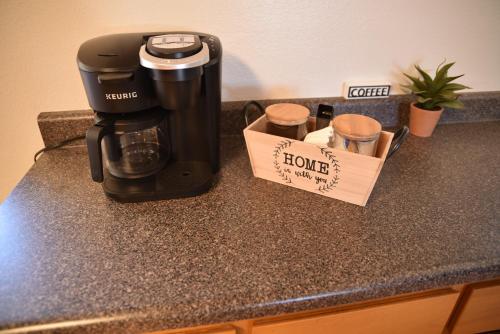 a coffeemaker sitting on a counter with a coffee maker at Rustic Western Home Steps from Rte 66 & Grand Canyon Train Station in Williams