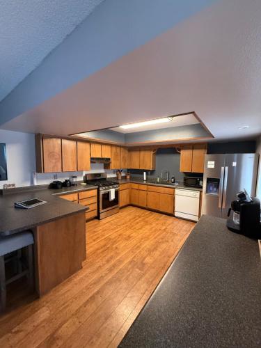 a large kitchen with wooden floors and wooden cabinets at Rustic Western Home Steps from Rte 66 & Grand Canyon Train Station in Williams