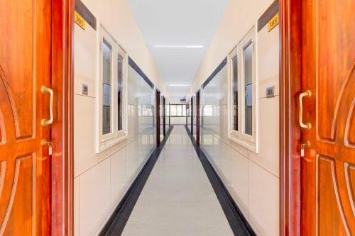 an empty corridor of a train with doors open at Hotel O Vellore Near CMC Hospital in Vellore