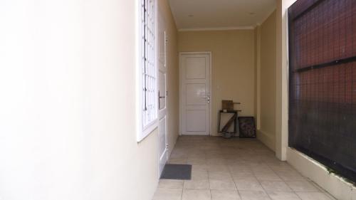 an empty hallway with a door and a chalkboard at Diyar Villas Puncak R7-3 in Puncak