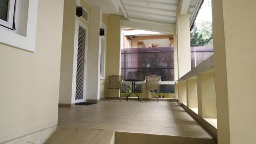 an empty hallway of a building with chairs in it at Diyar Villas Puncak R7-3 in Puncak