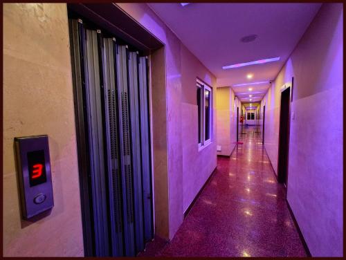 an empty hallway with purple lights in a building at Hotel BBluse - Sagar Near Sea Beach And Jagarnnath Temple # Parking and Lift Facilities # Bengali Market - Prime Location - BEST HOTELIN CITY in Puri
