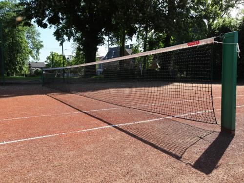 a tennis net on a tennis court at Group Villa with Pool & Sauna in Wanze
