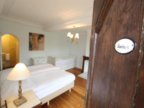 a bedroom with a bed and a table with a lamp at Group Villa with Pool & Sauna in Wanze