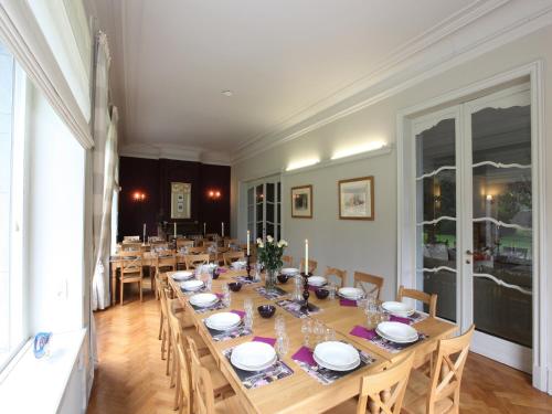 a large dining room with a long table with chairs at Group Villa with Pool & Sauna in Wanze