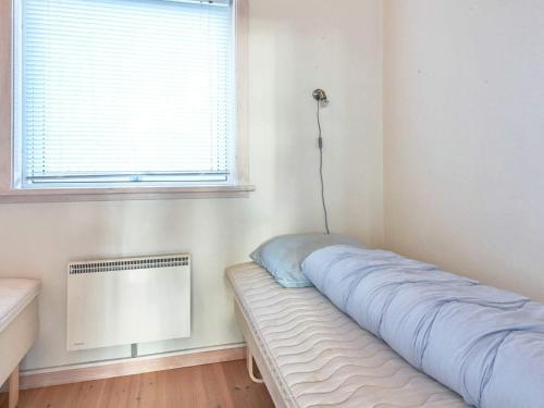 a bed in a room with a window at Idyllic Cottage in Allinge - By Traum Ferienwohnungen in Allinge
