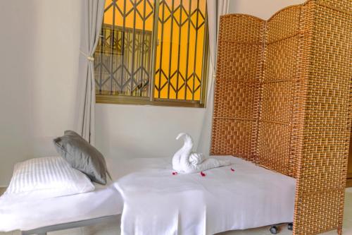 a room with a bed with a swan on it at Kounous Self-Catering Apartments in La Réunion