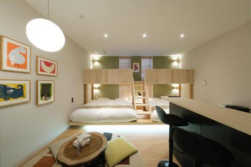 a bedroom with a bed and a bunk bed at Hotel QOL 瓦町 in Takamatsu