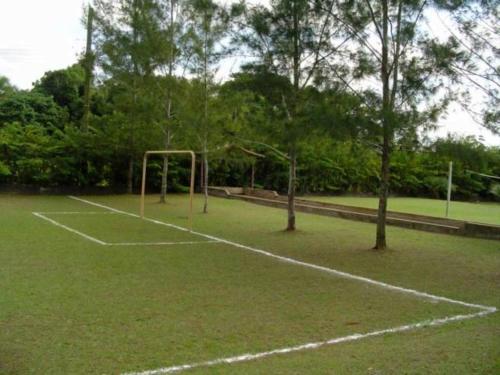 a soccer field with a goal on the grass at Samburá Chalés in Ilha Comprida