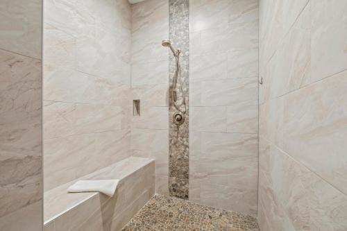a bathroom with a shower with a stone wall at 114 Mediterranean Way in Indian Harbour Beach