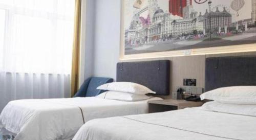 Ένα ή περισσότερα κρεβάτια σε δωμάτιο στο Yiwu Guomao Hotel