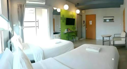 a hospital room with two beds and a table at A+ Hotel in Ubon Ratchathani