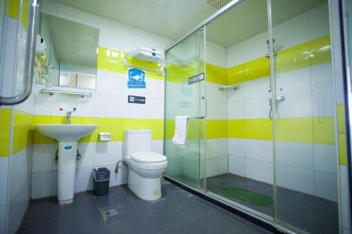 a bathroom with a shower and a toilet and a sink at 7 Days Inn Jinan Changqing Jingshi West Road Center in Jinan