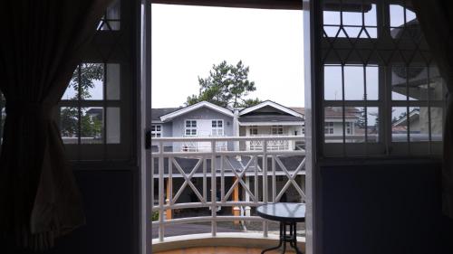 an open window with a view of a house at Diyar Villas Puncak Q4/11 in Puncak