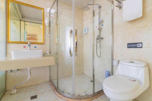 a bathroom with a shower and a toilet and a sink at Pai Hotel Tianjin Binguan Metro Station Municipal Government in Tianjin