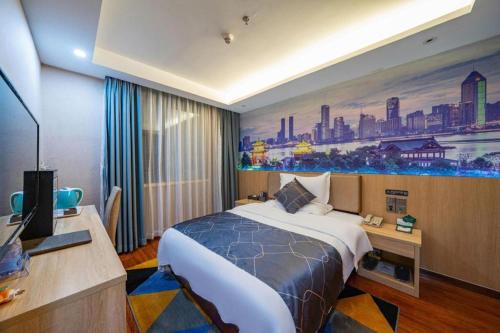 a hotel room with a bed and a painting on the wall at Chonpines Hotel Shenzhen Gongming Honghuashan Metro Station in Shenzhen