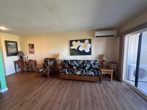 a living room with a couch and a table at Condos in Kapaa in Kapaa
