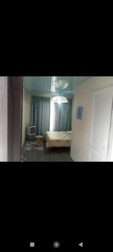 a room with a bed and a window and a door at Asian Guest House in Bishkek