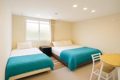 Postel nebo postele na pokoji v ubytování 池袋 巣鴨 YMhotel 最大18名可-ikebukuro sugamo-
