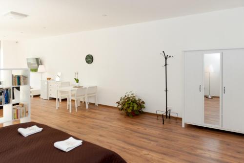 a living room with a bed and a dining room at Villa Ľadoveň LUXUSNÝ APARTMÁN 124m2 in Martin