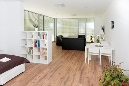 a bedroom with a bed and a desk and a table at Villa Ľadoveň LUXUSNÝ APARTMÁN 124m2 in Martin