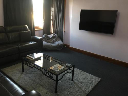 a living room with a couch and a coffee table at Rocklyn House in Moonah