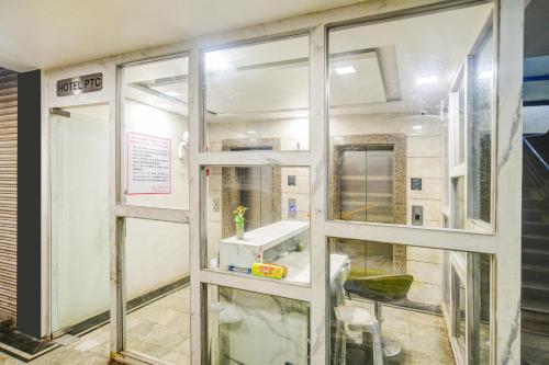 a bathroom with a window with a sink in it at Super Townhouse Oak PTC Indore Junction in Indore