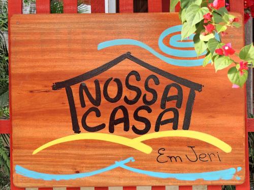 
a wooden bench with a picture of a dog on it at Nossa Casa em Jeri in Jericoacoara
