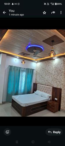 a bedroom with a bed with a blue light on the ceiling at Maa kamakhya home stay in Varanasi
