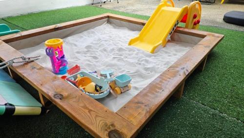 a wooden sandbox with a play set in it at Airini Pension in Damyang