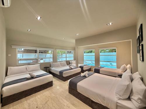 a large bedroom with two beds and a couch at Balinese Corner Private Pool Near Sunway Pyramid Upto 24P in Subang Jaya