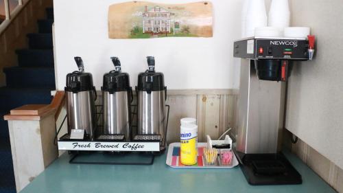 a counter with a coffee maker and a first arousal queue at King Charles Hotel in Ocean City