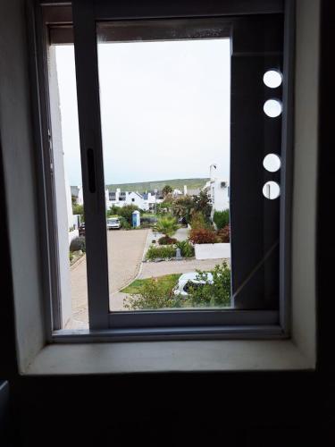 a window with a view of a parking lot at Tweede Lente in St Helena Bay