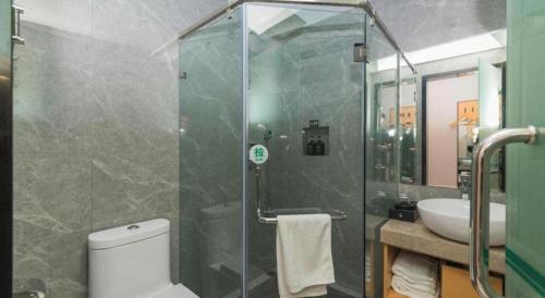 a bathroom with a shower and a toilet and a sink at Green Tree Inn Express Fuzhou Three Lanes and Seven Alleys Nanmendou Metro Station in Fuzhou